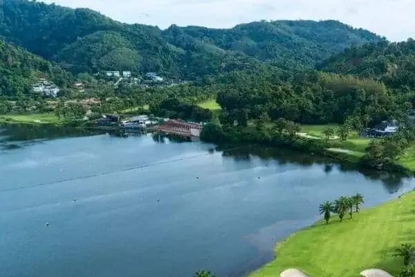 An aerial view of a golf course near a lake.